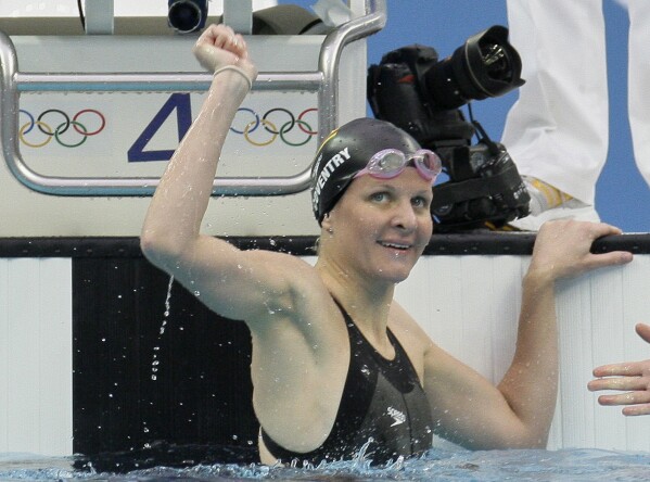 Zimbabwe's Kirsty Coventry reacts after setting a new world record in the women's 100-meter backstroke semi-finals during the swimming competitions in the National Aquatics Center at the Beijing 2008 Olympics in Beijing, Monday, Aug. 11, 2008. (AP Photo/David J. Phillip, File)