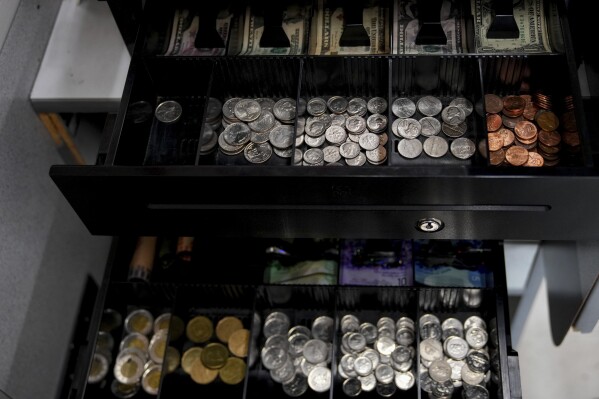 A cash register at the Point Roberts International Marketplace has two trays for both Canadian and U.S. currencies, Tuesday, March 18, 2025, in Point Roberts, Wash. (AP Photo/Lindsey Wasson)