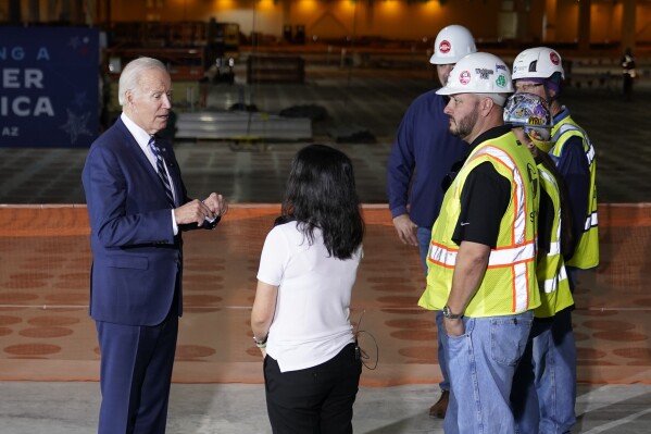 FILE - President Joe Biden tours the building site for a new computer chip plant for Taiwan Semiconductor Manufacturing Company, Tuesday, Dec. 6, 2022, in Phoenix. The Taiwanese microchip manufacturer building its first U.S. plant in Arizona has agreed to more scrutiny from the state when it comes to worker safety, Gov. Katie Hobbs said Friday, Aug. 4, 2023. (AP Photo/Patrick Semansky, File)