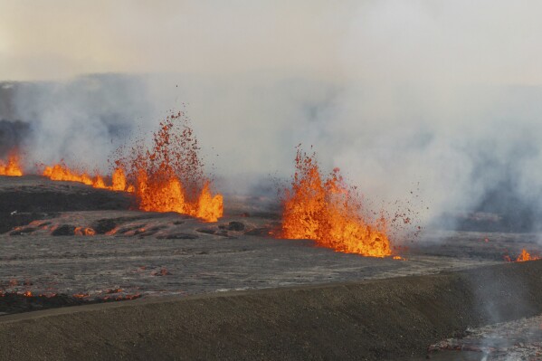 An areal view of the volcanic eruption near the town of Grindavik, on the Reykjanes Peninsula, Iceland, Tuesday, April 1, 2025. (AP Photo/Marco di Marco)