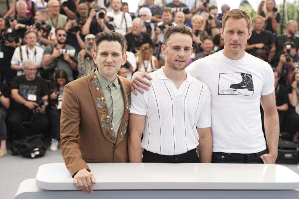 Harry Melling, from left, director Harry Lighton and Alexander Skarsgard pose for photographers at the photo call for the film 'Pillion' at the 78th international film festival, Cannes, southern France, Sunday, May 18, 2025. (Photo by Scott A Garfitt/Invision/AP)