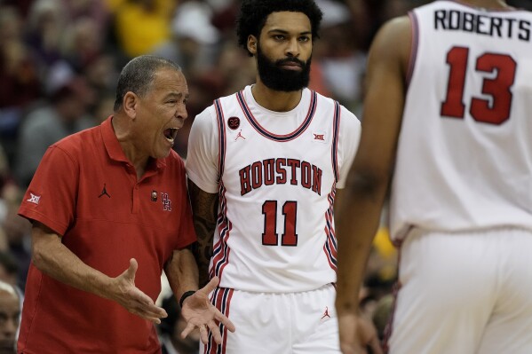 Houston head coach Kelvin Sampson talks to his players during the first half of an NCAA college basketball game against Iowa State in the championship of the Big 12 Conference tournament, Saturday, March 16, 2024, in Kansas City, Mo. (AP Photo/Charlie Riedel)