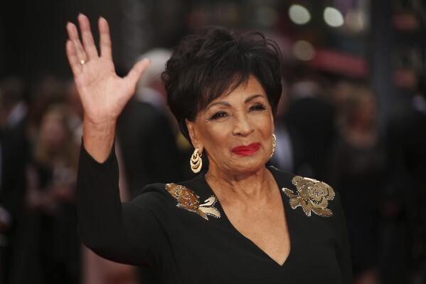 FILE - Dame Shirley Bassey poses for photographers upon arrival at the Olivier Awards in London, Sunday, April 3, 2016. Singer Shirley Bassey, director Ridley Scott and England goalkeeper Mary Earps were recognized Friday, Dec. 29, 2023 in the U.K.’s New Year Honors list, which celebrates the achievements and services of more than 1,000 people across the country. Other well-known names on the list include “The Great British Bake Off” judge Paul Hollywood, “Game of Thrones” actor Emilia Clarke, and Justin Welby, the Archbishop of Canterbury. (Photo by Joel Ryan/Invision/AP, File)