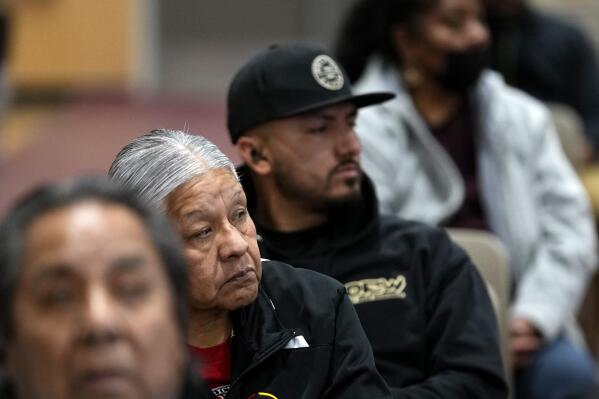 Residents of Gila River Indian Community listen during a "Road to Healing" event, Friday, Jan. 20, 2023, at the Gila Crossing Community School in Laveen, Ariz. The "The Road to Healing," is a year-long tour across the country to provide Indigenous survivors of the federal Indian boarding school system and their descendants an opportunity to share their experiences. (AP Photo/Matt York)