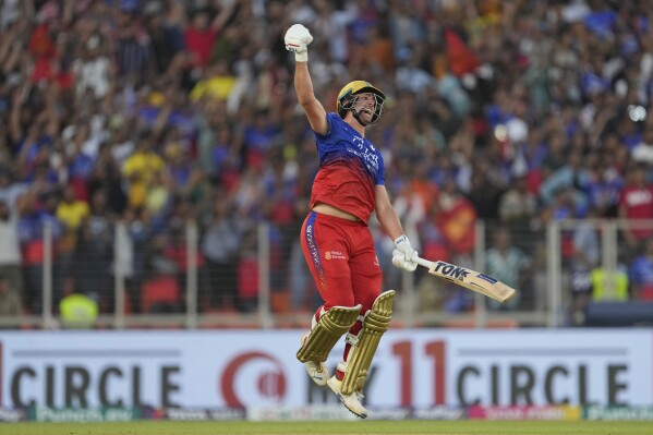 Royal Challengers Bengaluru's Will Jacks celebrates his century during the Indian Premier League cricket match between Gujarat Titans and Royal Challengers Bengaluru in Ahmedabad, India, Sunday, April 28, 2024. (AP Photo /Ajit Solanki)