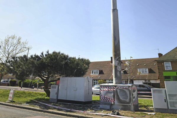 In this Tuesday, April 14, 2020 photo, a view of a cell tower after a fire, in Dagenham, England. Dozens of European cell towers have been destroyed in recent arson attacks that officials and wireless companies say are fueled by groundless conspiracy theories linking new 5G mobile networks and the coronavirus pandemic. (Stefan Rousseau/PA via AP)