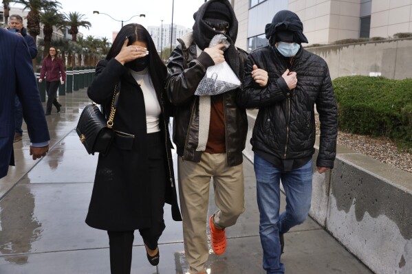 Former FBI informant Alexander Smirnov, center, leaves the courthouse on Tuesday, Feb. 20, 2024, in Las Vegas. Prosecutors say that Smirnov, who is charged with making up a multimillion-dollar bribery scheme involving President Joe Biden, his son Hunter and a Ukrainian energy company, had contacts with Russian intelligence-affiliated officials. (Bizuayehu Tesfaye/Las Vegas Review-Journal via AP)