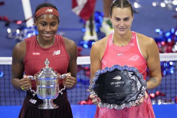 Coco Gauff, left, of the United States, poses for photographs with Aryna Sabalenka, of Belarus, at the women's singles final of the U.S. Open tennis championships, Saturday, Sept. 9, 2023, in New York. (AP Photo/John Minchillo)