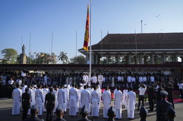 Sri Lankan President Anura Kumara Dissanayake, center, hoists the Sri Lankan national flag during the country's 77th Independence Day ceremony in Colombo, Sri Lanka, Tuesday, Feb. 4, 2025. (AP Photo/Eranga Jayawardena)