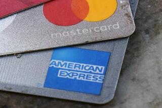 FILE - American Express, Visa and Master card cards are on display in Richmond, Va., Thursday, July 1, 2021.  A group of Republican attorneys general are pushing the major payment networks _ Visa, Mastercard and American Express _ to drop their plans to start tracking sales at gun stores, arguing the plans could infringe on consumer privacy and push legal gun sales out of the mainstream financial network. The letter comes more than a week after the payment networks said they would adopt the International Organization for Standardization’s new merchant code for sales at gun stores.   (AP Photo/Steve Helber)