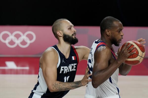 United States' Khris Middleton (8) drives ahead of France's Evan Fournier (10) during men's basketball gold medal game at the 2020 Summer Olympics, Saturday, Aug. 7, 2021, in Saitama, Japan. (AP Photo/Luca Bruno)