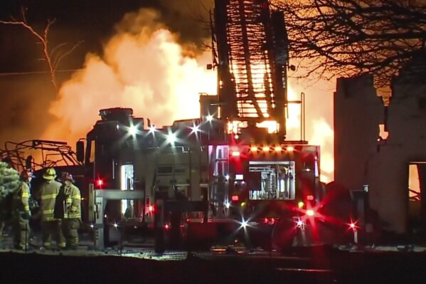 In this frame grab taken from video provided by WXYZ, firefighters battle an industrial fire in the Detroit suburb of Clinton Township, late Monday, March 4, 2024. (Courtesy of WXYZ via AP)