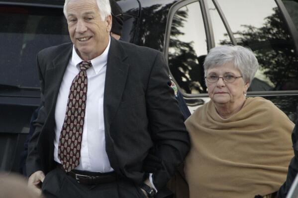 FILE - In this Dec. 13, 2011 file photo, former Penn State assistant football coach Jerry Sandusky arrives with his wife, Dottie Sandusky, for a preliminary hearing at the Centre County Courthouse in Bellefonte, Pa. Dottie Sandusky says it was long after he’d been arrested, tried and convicted before she realized just how much trouble the former Penn State assistant football coach had gotten himself into.  In an interview this week at her home in State College, Dottie Sandusky said that even after his 45-count guilty verdict in the child molestation case, she still had had hope.  But when the judge gave him to 30 to 60 years in state prison, she said, she fully comprehended the trouble he was in.  She’s been granting interviews in recent weeks, arguing her husband’s conviction was unjust and claiming the victims who testified against him told inaccurate stories to cash in. An attorney involved in negotiating with Penn State on behalf of his victims calls her denials “obscene.”  (AP Photo/Gene J. Puskar, File)