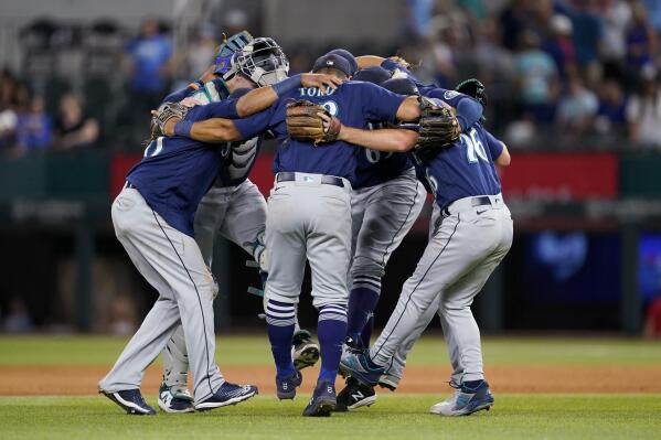 The Seattle Mariners celebrate s 6-5 win over the Texas Rangers in a baseball game Thursday, July 14, 2022, in Arlington, Texas. (AP Photo/Tony Gutierrez)