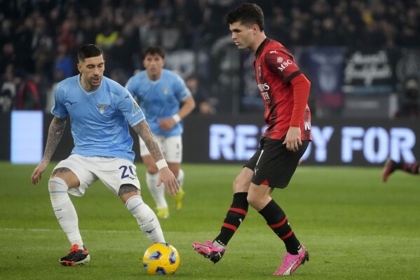 AC Milan's Christian Pulisic, right, and Lazio's Mattia Zaccagni vie for the ball during the Italian Serie A soccer match between Lazio and Milan at Rome's Olympic stadium, Friday, March 1, 2024. (APPhoto/Gregorio Borgia)