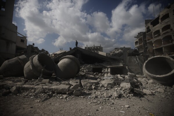 A Palestinian stands on top of a mosque destroyed in an Israeli strike in Rafah, Gaza Strip, Thursday, Feb. 22, 2024. (AP Photo/Mohammed Dahman)