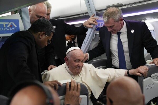 Pope Francis leaves at the end of a press conference on his flight back from Marseille to Rome, Saturday, Sept. 23, 2023. Francis just ended a two-day visit to Marseille where he joined Catholic bishops from the Mediterranean region on discussions largely focused on migration. (AP Photo/Alessandra Tarantino, Pool)