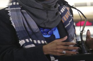 In this Jan. 22, 2019 photo, Rep. Ilhan Omar, D-Minn., addresses reporters in Minneapolis. Omar has officially divorced from her husband in Minnesota, just a month after she filed a petition saying there was an "irretrievable breakdown" in their marriage. (AP Photo/Jim Mone)