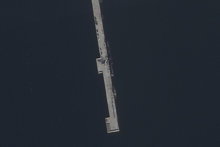 In this satellite photo taken by Planet Labs PBC, a submarine, center, is seen at the North Korean port of Sinpo Thursday, Sept. 7, 2023. North Korea said Friday, Sept. 8, 2023, its new submarine has nuclear attack capabilities. It's been developing for years, a step leader Kim Jong Un described as crucial in his efforts to build a nuclear-armed navy to counter the United States and its Asian allies. Satellite photos analyzed by The Associated Press on Friday placed the submarine and the ceremony that Kim took part in at the port city of Sinpo. (Planet Labs PBC via AP)
