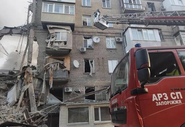 In this photo provided by the Ukrainian Emergency Service, rescuers work on a scene of building damaged by shelling in Zaporizhzhia, Ukraine, Thursday, Oct. 6, 2022. (Ukrainian Emergency Service via AP)