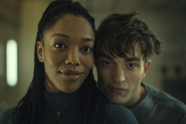 This image released by Warner Bros. Pictures shows Naomi Ackie, left, and Robert Pattinson in a scene from "Mickey 17." (Warner Bros. Pictures via AP)