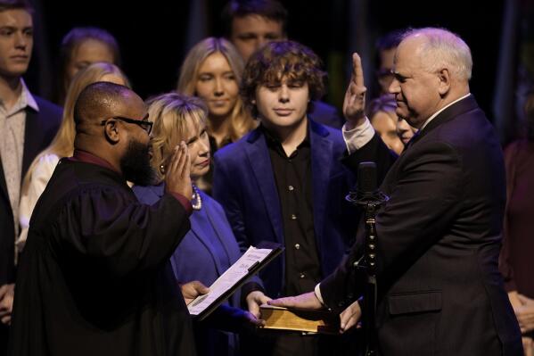 Minnesota Gov. Tim Walz, right, is sworn in by Judge Johnathan Judd, Seventh Judicial Circuit, during his inauguration for his second term, Monday, Jan. 2, 2023, in St. Paul, Minn. (AP Photo/Abbie Parr)