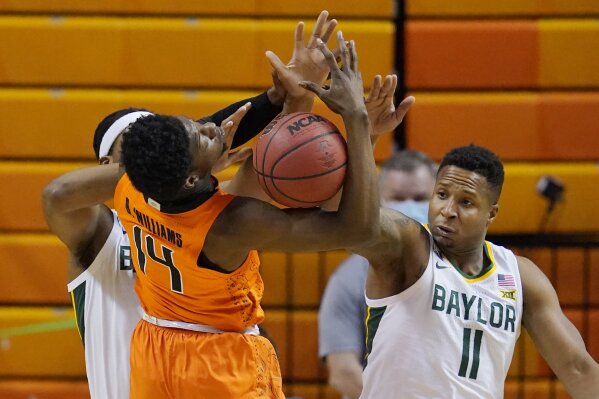 Baylor forward Flo Thamba, left, and guard Mark Vital (11) knock the ball away from Oklahoma State guard Bryce Williams (14) in the first half of an NCAA college basketball game, Saturday, Jan. 23, 2021, in Stillwater, Okla. (AP Photo/Sue Ogrocki)