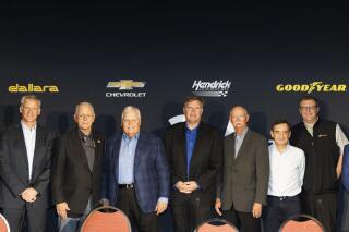 In a photo provided by IMSA, NASCAR President Steve Phelps; IMSA and NASCAR CEO Jim France; Rick Hendrick, Jim Campbell of Chevrolet; Stu Grant of Goodyear; ACO President Pierre Fillon; and IMSA President John Doonan gather at the announcement of a 2023 LeMans "Garage 56" program featuring a NASCAR Chevrolet Camaro car from Hendrick Motorsports. (Michael L. Levitt/LAT/IMSA via AP)