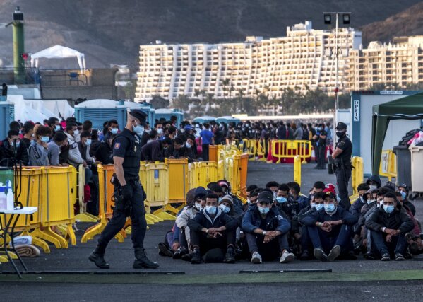 Migrants stand at the Arguineguin port in Gran Canaria island, Spain, after being rescued in the Atlantic Ocean by emergency workers on Thursday, Oct. 19, 2020. Under increasing pressure from the steady build-up of Africans' arrivals to its southern Canary Islands, the Spanish government has launched an all-front offensive, including active diplomacy, to avoid becoming the next black spot on Europe's failing record handling migration flows. (AP Photo/Javier Bauluz)