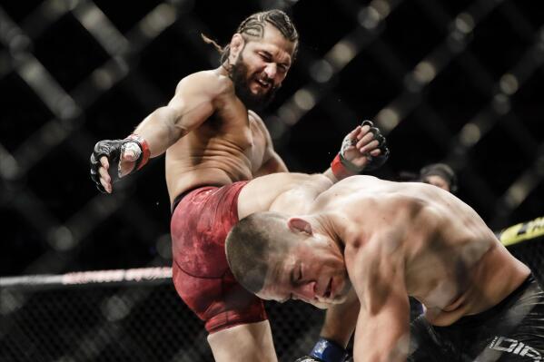 FILE - Jorge Masvidal, left, kicks Nate Diaz during the first round of a welterweight mixed martial arts bout at UFC 244 in New York, in this early Sunday, Nov. 3, 2019, file photo. UFC 261 is being touted as the first full-capacity sporting event held indoors in more than a year. The card features three title fights, highlighted by a rematch between reigning welterweight champion Kamaru “Nigerian Nightmare” Usman (18-1) and Jorge “King of Miami” Masvidal (35-14). (AP Photo/Frank Franklin II, File)