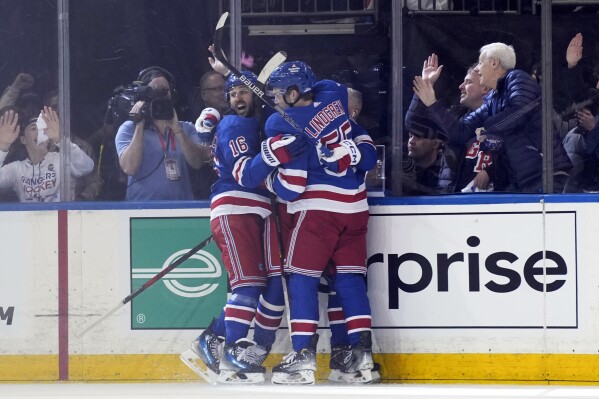 New York Rangers' Vincent Trocheck, left, celebrates after a goal by Artemi Panarin during the second period in Game 1 of an NHL hockey Stanley Cup first-round playoff series against the Washington Capitals, Sunday, April 21, 2024, in New York. (AP Photo/Seth Wenig)