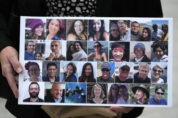 FILE - A photo collage of the 34 victims of the Sept. 2, 2019 fire aboard the dive boat, Conception, at Santa Cruz Island, is held by a family member arriving at federal court in Los Angeles, Wednesday, Oct. 25, 2023. A federal jury on Monday, Nov. 6, found scuba dive boat captain Jerry Boylan was criminally negligent in the deaths of 34 people killed in a fire aboard the vessel in 2019, the deadliest maritime disaster in recent U.S. history. (AP Photo/Damian Dovarganes,File)