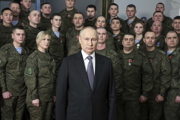 FILE - President Vladimir Putin speaks in his annual televised New Year's message after a ceremony during a visit to the headquarters of the Southern Military District, at an unknown location in Russia, on Dec. 31, 2022. Putin on Friday Dec. 8, 2023 moved to prolong his repressive and unyielding grip on Russia for another six years, announcing his candidacy in the 2024 presidential election that he is all but certain to win.(Mikhail Klimentyev, Sputnik, Kremlin Pool Photo via AP, File)