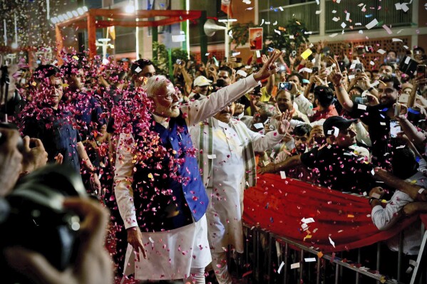 Prime Minister Narendra Modi is greeted by supporters as he arrives at Bharatiya Janata Party (BJP) headquarters in New Delhi, India, Tuesday, June 4, 2024. (AP Photo/Manish Swarup)