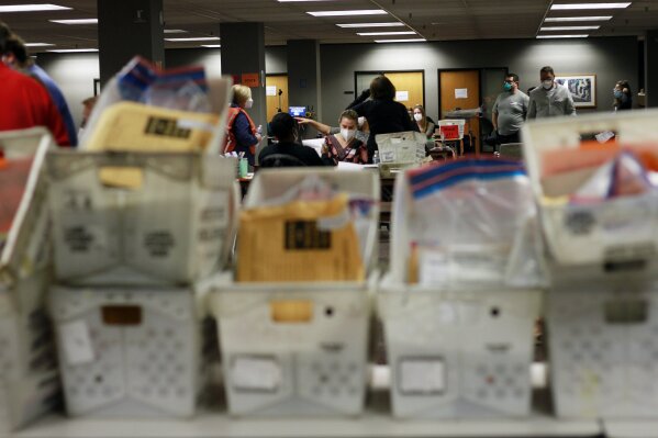 Election workers count absentee ballots into the early morning, Wednesday, Nov. 4, 2020 in Milwaukee at a central counting facility. (AP Photo/Stephen Groves)