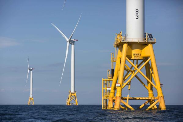 FILE - Offshore wind turbines stand near Block Island, R.I. on Aug. 15, 2016. The developers of an offshore wind farm off the coast of New England and New York and three environmental organizations have reached an agreement Monday, June 27, 2022, to further protect rare North Atlantic right whales during construction and operation of the energy-generating project. (AP Photo/Michael Dwyer, File)