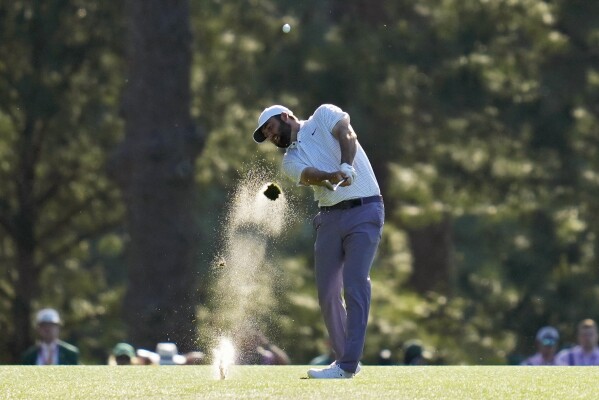 Scottie Scheffler hits from the fairway on the 14th hole during third round at the Masters golf tournament at Augusta National Golf Club Saturday, April 13, 2024, in Augusta, Ga. (AP Photo/Ashley Landis)