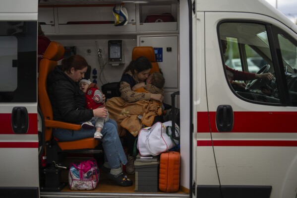 Patients are evacuated from Children's Hospital No. 1 on the outskirts of Kyiv, Ukraine, Friday, April 26, 2024. Doctors and ambulance crews evacuated patients from a Kyiv children's hospital on Friday after a video circulated online saying Russia planned to attack it. (AP Photo/Francisco Seco)