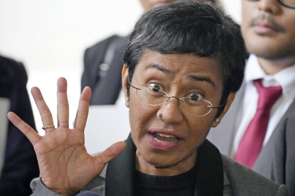 Filipino journalist Maria Ressa, 2021 Nobel Peace Prize winner and Rappler CEO, gestures as she talks to reporters after being acquitted by the Pasig Regional Trial Court over a tax evasion case in Pasig city, Philippines on Tuesday, Sept. 12, 2023. (AP Photo/Aaron Favila)