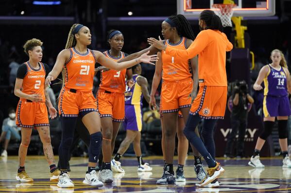 The Connecticut Sun celebrate a 75-57 win over the Los Angeles Sparks after their WNBA basketball game Thursday, Sept. 9, 2021, in Los Angeles. (AP Photo/Ashley Landis)