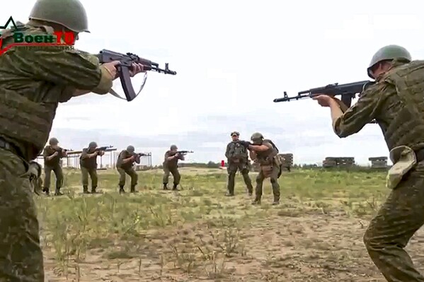 In this photo taken from video released by Belarusian Defense Ministry via VoenTV on Friday, July 14, 2023, Belarusian soldiers attend a training by mercenary fighters from Wagner private military company near Tsel village, about 90 kilometers (about 55 miles) southeast of Minsk, Belarus. Mercenary fighters from the Wagner private military company are training Belarusian soldiers in Belarus, the country's Defense Ministry said Friday. Russian President Vladimir Putin said he offered the Wagner private military company the option of continuing to serve as a single unit under their same commander. (Belarusian Defense Ministry via VoenTV via AP)