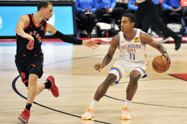 Toronto Raptors' Malachi Flynn, left, defends Oklahoma City Thunder's Theo Maledon, right, during the third quarter of a basketball game Sunday, April 18, 2021, in St. Petersburg, Fla. (AP Photo/Steve Nesius)