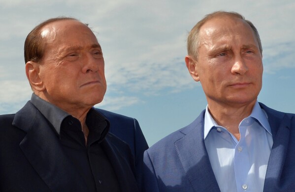 FILE - Russian President Vladimir Putin, right, and former Italian Prime Minister Silvio Berlusconi visit a memorial to the soldiers from Sardinia killed in the Crimean War, near Mount Gasfort outside Sevastopol in Crimea, Friday, Sept. 11, 2015. Berlusconi, the boastful billionaire media mogul who was Italy's longest-serving premier despite scandals over his sex-fueled parties and allegations of corruption, died, according to Italian media. He was 86.(Alexei Druzhinin/RIA-Novosti, Kremlin Pool Photo via AP, File)