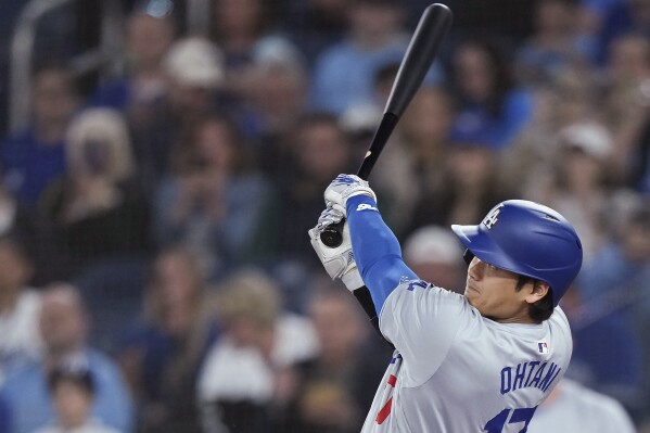 Los Angeles Dodgers designated hitter Shohei Ohtani watches his solo home run against the Toronto Blue Jays during the first inning of a baseball game Friday, April 26, 2024, in Toronto. (Nathan Denette/The Canadian Press via AP)