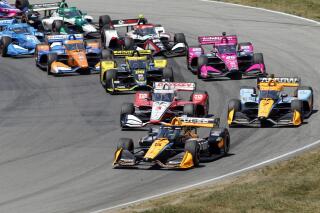 Pato O'Ward leads the field at the drop of the green flag during an IndyCar auto race at Mid-Ohio Sports Car Course in Lexington, Ohio, Sunday, July 3, 2022. (AP Photo/Tom E. Puskar)
