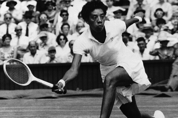 Althea Gibson of  New York  makes a low return to Darlene Hard of Montebello, Calif., in their title match in All-England Lawn Tennis Championships at Wimbledon, England July 6, 1957. Miss Gibson defeated Miss Hard 6-3, 6-2 to become the first African Amiercan to ever to win a Wimbledon title. (ĢӰԺ Photo)