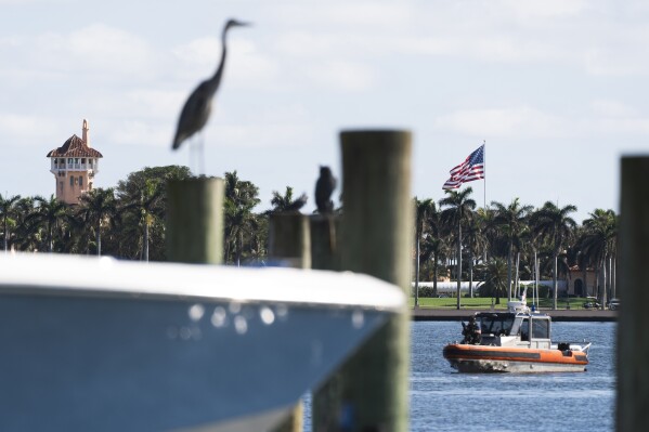 The U.S. flag is shown at the Mar-a-Lago compound in Palm Beach, Fla., while a U.S. Coast Guard boat patrols around the vicinity, Monday, Jan. 13, 2025. U.S. flags at President-elect Donald Trump's private Mar-a-Lago club are back to flying at full height. Flags are supposed to fly at half-staff through the end of January out of respect for former President Jimmy Carter, who died Dec. 29. (AP Photo/Manuel Balce Ceneta)