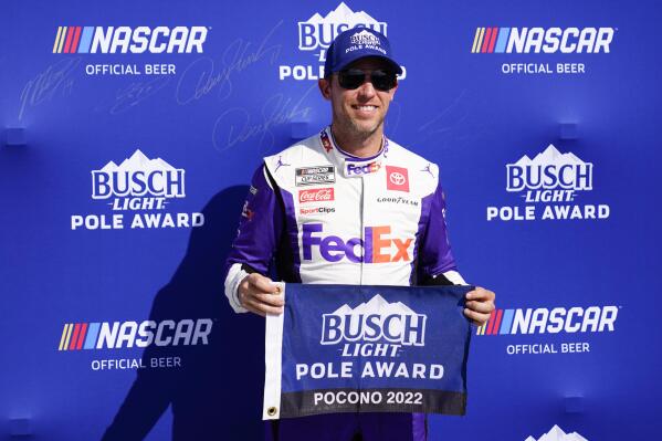 Chris Buescher poses after qualifying for the pole position for the NASCAR Cup Series at Pocono Raceway, Saturday, July 23, 2022 in Long Pond, Pa. (AP Photo/Matt Slocum)