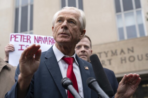 Former Trump White House official Peter Navarro talks to the media as he leaves the U.S. Federal Courthouse in Washington, Thursday, Jan. 25, 2024. Navarro, who was convicted of contempt of Congress for refusing to cooperate with a congressional investigation into the Jan. 6, 2021, attack on the U.S. Capitol, and sentenced on Thursday to four months behind bars. (AP Photo/Jose Luis Magana)