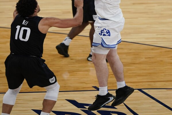 Xavier's Zach Freemantle, right, shoots over Butler's Bryce Nze during the second half of an NCAA college basketball game in the Big East conference tournament Wednesday, March 10, 2021, in New York. (AP Photo/Frank Franklin II)